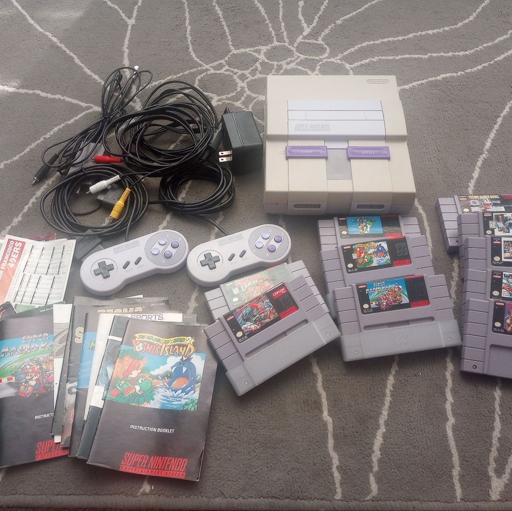 Super Nintendo entertainment console, two controllers and 10 games.